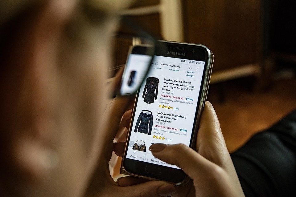 A woman using her smartphone to shop online