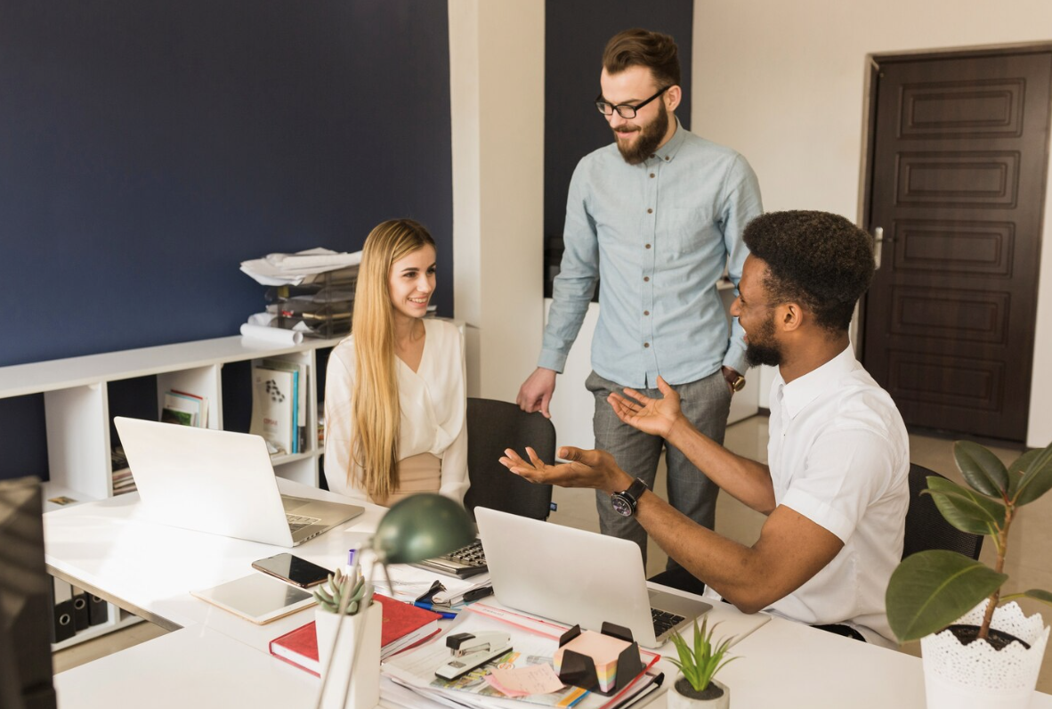 A team of digital marketing professionals brainstorming and collaborating on new strategies in an office setting