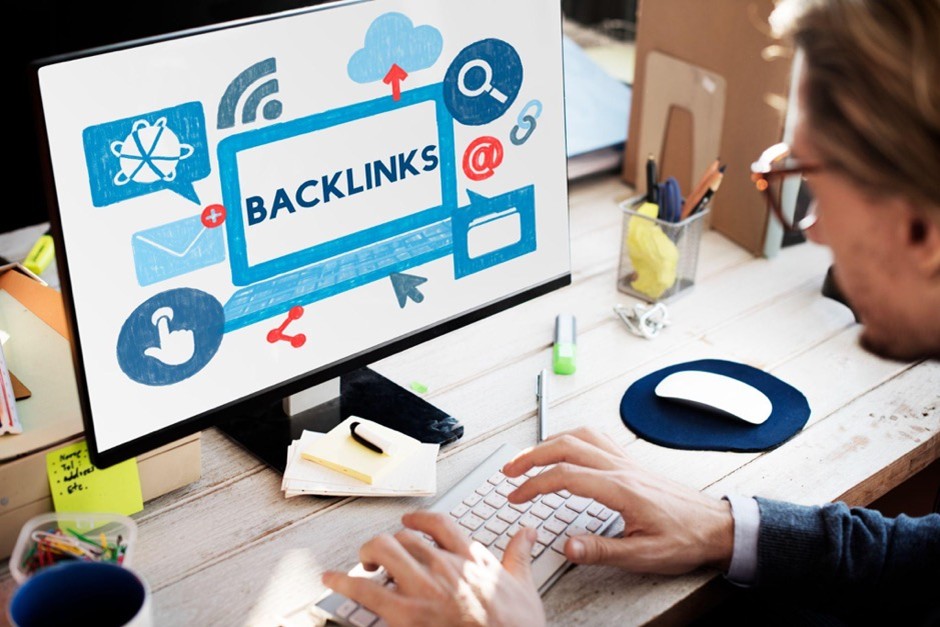 A person working on a computer showing a backlink strategy and an authority development screen to drive measurable SEO growth.